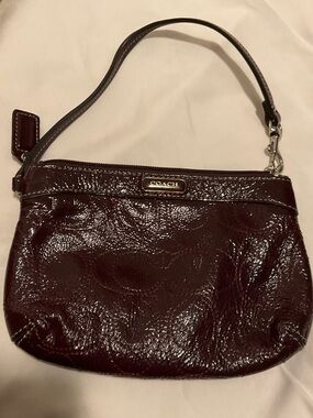 COACH Glossy Patent Wristlet in Burgundy